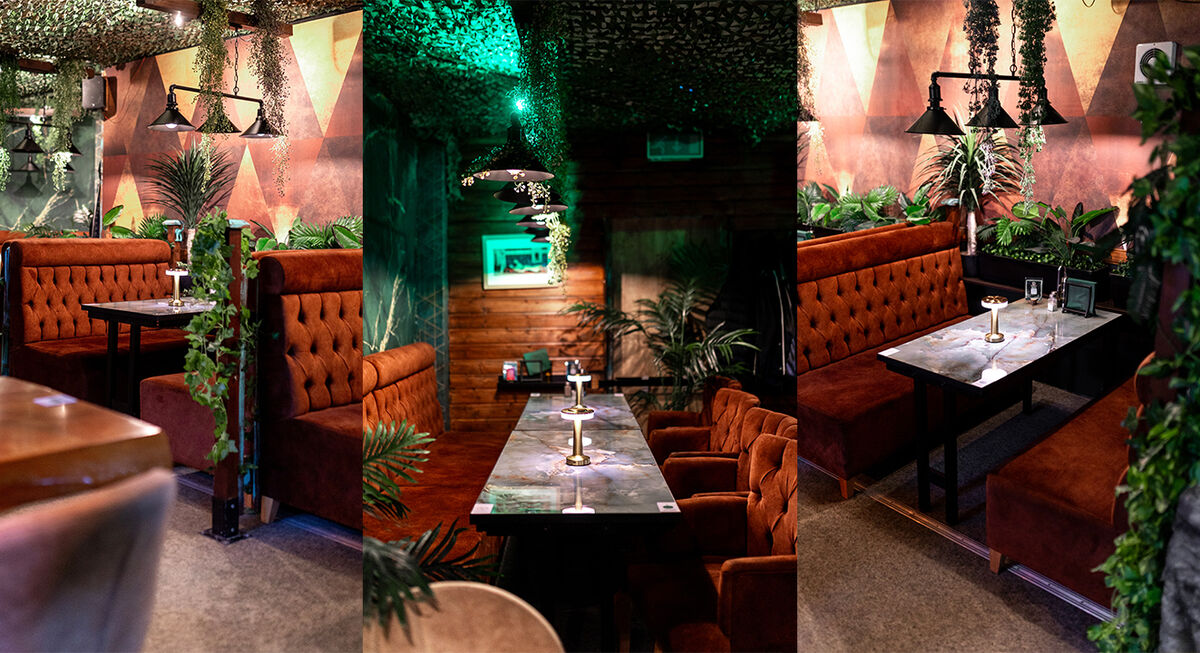 Inside Dahhan's Café - velvet booths, marble tables and hanging greenery
